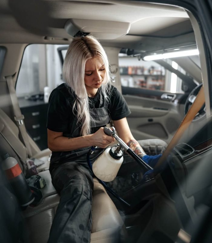 woman-cleaning-car-salon-with-polishing-spray-in-car-detailing-service.jpg